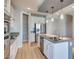 Modern kitchen with white cabinets, stainless steel appliances, an island, and a walk-in pantry at 10342 Kesington Dr, Las Vegas, NV 89135