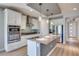 Modern kitchen with stainless steel appliances, island, and white cabinetry at 10342 Kesington Dr, Las Vegas, NV 89135