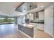 Modern kitchen and living area featuring stainless steel appliances and island at 10342 Kesington Dr, Las Vegas, NV 89135