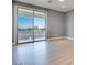Upstairs living area with vinyl floors and a large sliding glass door leading to a balcony and amazing views at 10342 Kesington Dr, Las Vegas, NV 89135