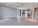 Open floor plan with a kitchen, staircase, and bright living room with modern lighting at 10342 Kesington Dr, Las Vegas, NV 89135
