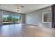 Spacious living room with large sliding glass doors and modern light fixtures at 10342 Kesington Dr, Las Vegas, NV 89135