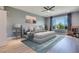 Serene bedroom with a king-sized bed, ceiling fan, and abundant natural light at 10342 Kesington Dr, Las Vegas, NV 89135