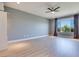 This main bedroom features large windows with curtains and vinyl floors, creating a modern and airy atmosphere at 10342 Kesington Dr, Las Vegas, NV 89135