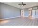 This expansive main bedroom offers plenty of space and natural light with vinyl floors and neutral gray paint at 10342 Kesington Dr, Las Vegas, NV 89135