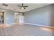 Spacious main bedroom features a ceiling fan, vinyl floors, and an ensuite bathroom for added convenience at 10342 Kesington Dr, Las Vegas, NV 89135