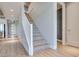 Hallway featuring stairs and front door, with modern finishes and light wood floors at 10342 Kesington Dr, Las Vegas, NV 89135