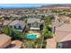 A high-angle shot shows houses with pools in the backyard in a packed neighborhood in the desert at 11844 Mino Rio Ave, Las Vegas, NV 89138