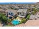 Aerial view of the backyard oasis with pool, spa, and covered patio in a Gathering-friendly neighborhood at 11844 Mino Rio Ave, Las Vegas, NV 89138