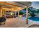 Resort-style backyard featuring pool, spa, covered patio, and lush landscaping at 11844 Mino Rio Ave, Las Vegas, NV 89138