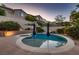 Beautiful backyard pool with spa, surrounded by lush landscaping, hardscape, and retaining wall at 11844 Mino Rio Ave, Las Vegas, NV 89138