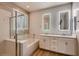 Bright bathroom featuring double sinks, subway tile, and a shower/tub combo at 11844 Mino Rio Ave, Las Vegas, NV 89138