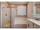 Modern bathroom with tub shower combo, sleek vanity, and bright natural light at 11844 Mino Rio Ave, Las Vegas, NV 89138
