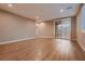 Spacious bedroom with wood-look floors and sliding glass door to outdoors at 11844 Mino Rio Ave, Las Vegas, NV 89138