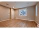 Spacious bedroom with natural light, wood floors, and neutral colors, perfect for relaxation at 11844 Mino Rio Ave, Las Vegas, NV 89138