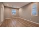 Well-lit bedroom featuring wood floors and multiple windows with shutters at 11844 Mino Rio Ave, Las Vegas, NV 89138