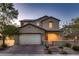 Charming two-story home with a brick driveway and well-manicured front yard at 11844 Mino Rio Ave, Las Vegas, NV 89138