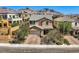 Charming two-story home with well-maintained landscaping, a brick driveway, and a mountain view at 11844 Mino Rio Ave, Las Vegas, NV 89138