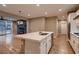 Open-concept kitchen with stainless steel appliances, island, and a view of the living area and backyard at 11844 Mino Rio Ave, Las Vegas, NV 89138