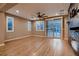 Bright living room with wood floors, a modern fireplace, and sliding glass doors to the backyard at 11844 Mino Rio Ave, Las Vegas, NV 89138