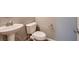Cozy powder room with pedestal sink, modern faucet, and low flow toilet at 11844 Mino Rio Ave, Las Vegas, NV 89138
