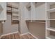 Spacious walk-in closet with custom shelving and wood-look floors at 11844 Mino Rio Ave, Las Vegas, NV 89138