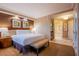 Relaxing main bedroom featuring king bed, tub, and neutral carpet creating an inviting space at 125 E Harmon Ave # 2801 & 2803, Las Vegas, NV 89109