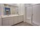 Bright bathroom with double sinks, stone countertops, and a glass-enclosed shower for a spa-like experience at 139 Aqua Commons Ln, Henderson, NV 89015