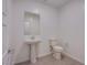 Fresh powder room featuring a pedestal sink, mirror, and tiled floors, perfect for guests at 139 Aqua Commons Ln, Henderson, NV 89015