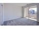 Carpeted bedroom with natural light and sliding doors leading to a private balcony at 139 Aqua Commons Ln, Henderson, NV 89015