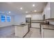 Modern kitchen features stainless steel appliances, a gray counter island, and ample lighting at 139 Aqua Commons Ln, Henderson, NV 89015