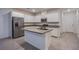 Modern kitchen features an island with sink, stainless steel appliances, and ample cabinetry at 139 Aqua Commons Ln, Henderson, NV 89015