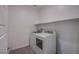 Well-lit laundry room with modern washer, dryer, and storage shelf for efficient organization at 139 Aqua Commons Ln, Henderson, NV 89015