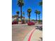 Gated community entrance with mature trees and a red car at 1500 Cardinal Peak Ln # 201, Las Vegas, NV 89144