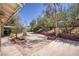Spacious backyard featuring decorative brickwork, drought tolerant landscaping, and a patio area at 1590 Desertaire Way, Las Vegas, NV 89110