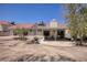 Wide shot of a backyard featuring a covered patio, desert landscaping and some patio furniture at 1590 Desertaire Way, Las Vegas, NV 89110