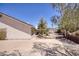 Spacious backyard featuring desert landscaping, block wall and a covered patio at 1590 Desertaire Way, Las Vegas, NV 89110