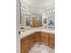 Bathroom featuring dual sinks, tile countertops, and large vanity mirrors at 1590 Desertaire Way, Las Vegas, NV 89110