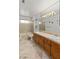 Spacious bathroom featuring dual sinks, tiled counters, and a glass-enclosed shower at 1590 Desertaire Way, Las Vegas, NV 89110