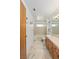 Bright bathroom with tiled vanity, glass shower door, and ample natural light at 1590 Desertaire Way, Las Vegas, NV 89110