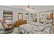 Comfortable bedroom with dual beds, rocking chair and a large window for natural light at 1590 Desertaire Way, Las Vegas, NV 89110