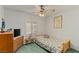 Cozy bedroom featuring a ceiling fan, window shutters, and a twin bed at 1590 Desertaire Way, Las Vegas, NV 89110