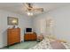 Bedroom features a ceiling fan, window shutters, and a full sized bed at 1590 Desertaire Way, Las Vegas, NV 89110