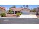 Charming single-story home with a well-maintained front yard and an attached two-car garage at 1590 Desertaire Way, Las Vegas, NV 89110