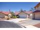 Inviting single-Gathering home featuring a tile roof, landscaped front yard, and two-car garage at 1590 Desertaire Way, Las Vegas, NV 89110