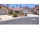 Beautiful home with desert landscaping, a tile roof, and attached garage in a quiet neighborhood at 1590 Desertaire Way, Las Vegas, NV 89110