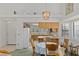 Kitchen adjacent to dining area, featuring white appliances and tile countertops at 1590 Desertaire Way, Las Vegas, NV 89110
