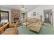 Bright living room with a brick fireplace, and comfortable seating arrangements at 1590 Desertaire Way, Las Vegas, NV 89110