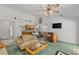 Inviting living room with high ceilings, a ceiling fan, and a bar area adjacent to the kitchen at 1590 Desertaire Way, Las Vegas, NV 89110