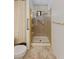 Bathroom featuring an accessible shower with grab bar and tiled walls at 1590 Desertaire Way, Las Vegas, NV 89110
